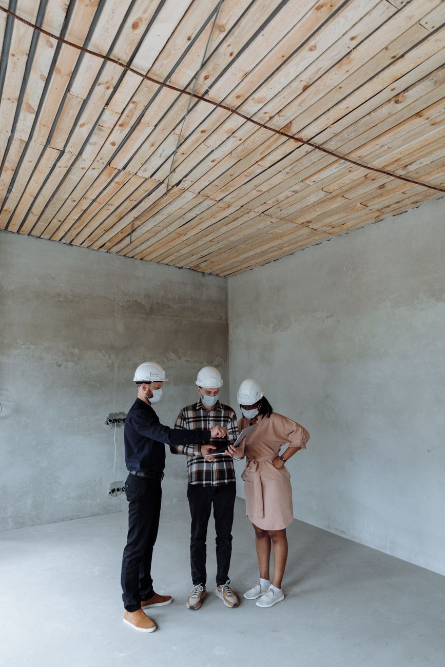 Architectural interior installation team inspecting stretch ceiling frame